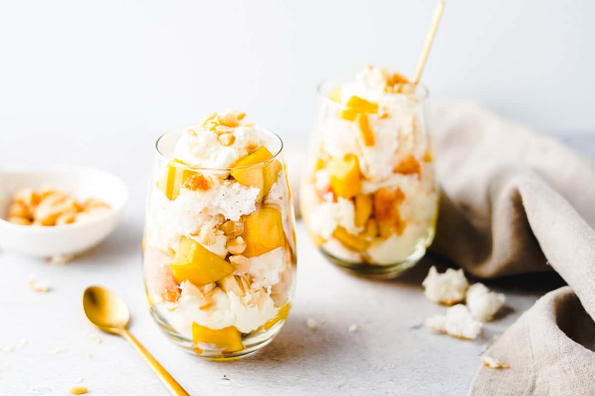 Mango Trifles in 2 Glasses with Macadamia Nuts in the Background