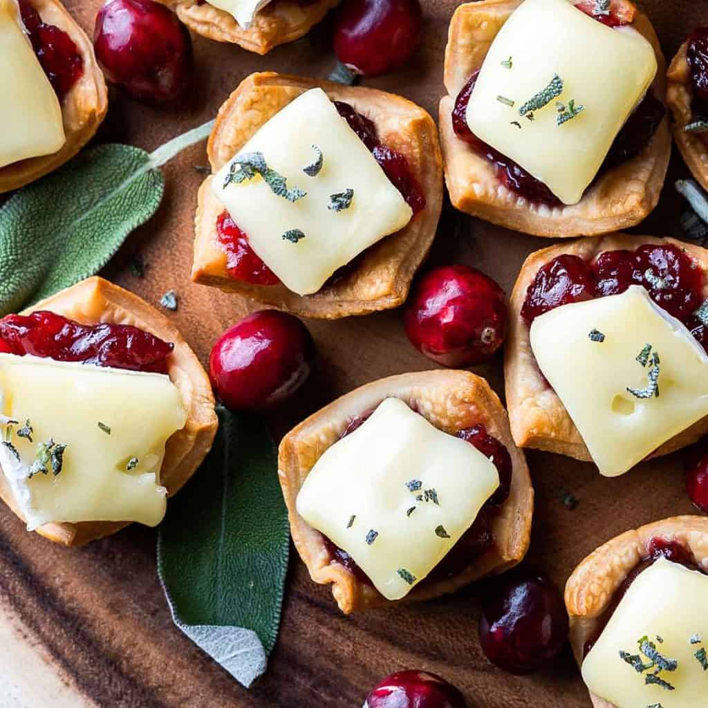 Cranberry Brie Tarts with cranberries and sage on the side