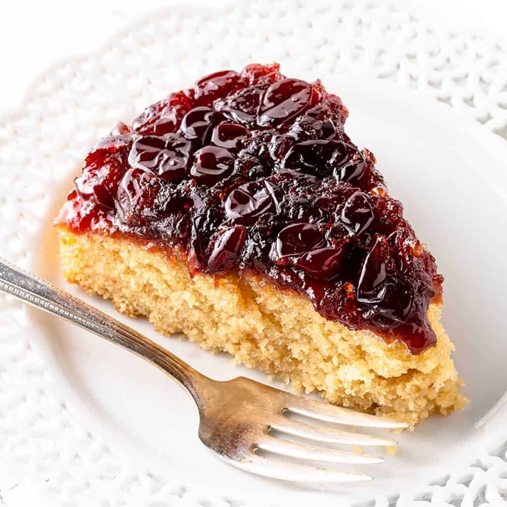 Slice of Cranberry Upside Down Cake on Plate with Fork