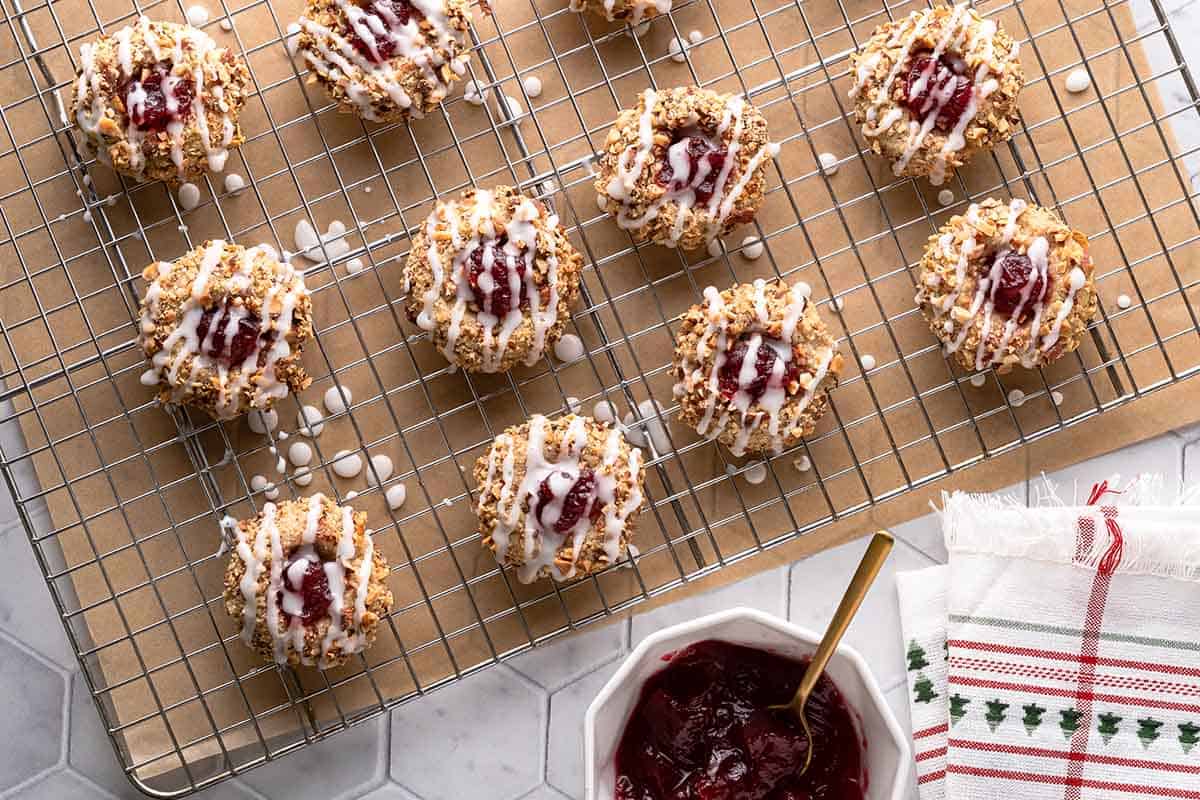 cranberry thumbprint cookies on wire rack with cranberry sauce