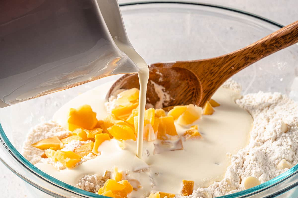 cream being poured into dry scone ingredients