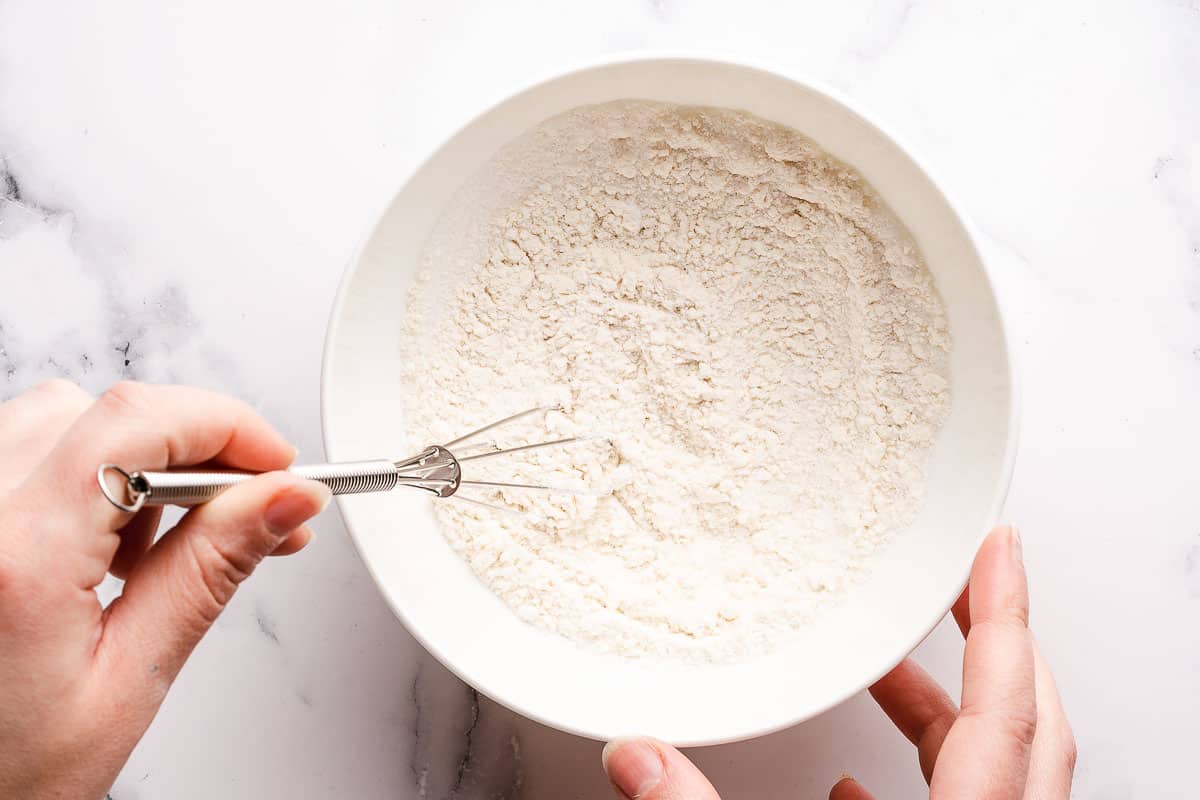 mixing dry ingredients in small bowl with small whisk