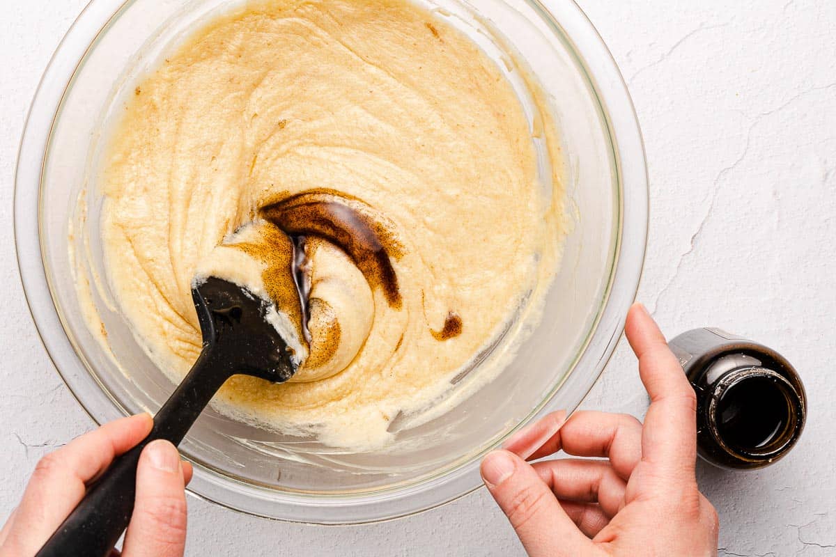vanilla being stirred into brownie batter