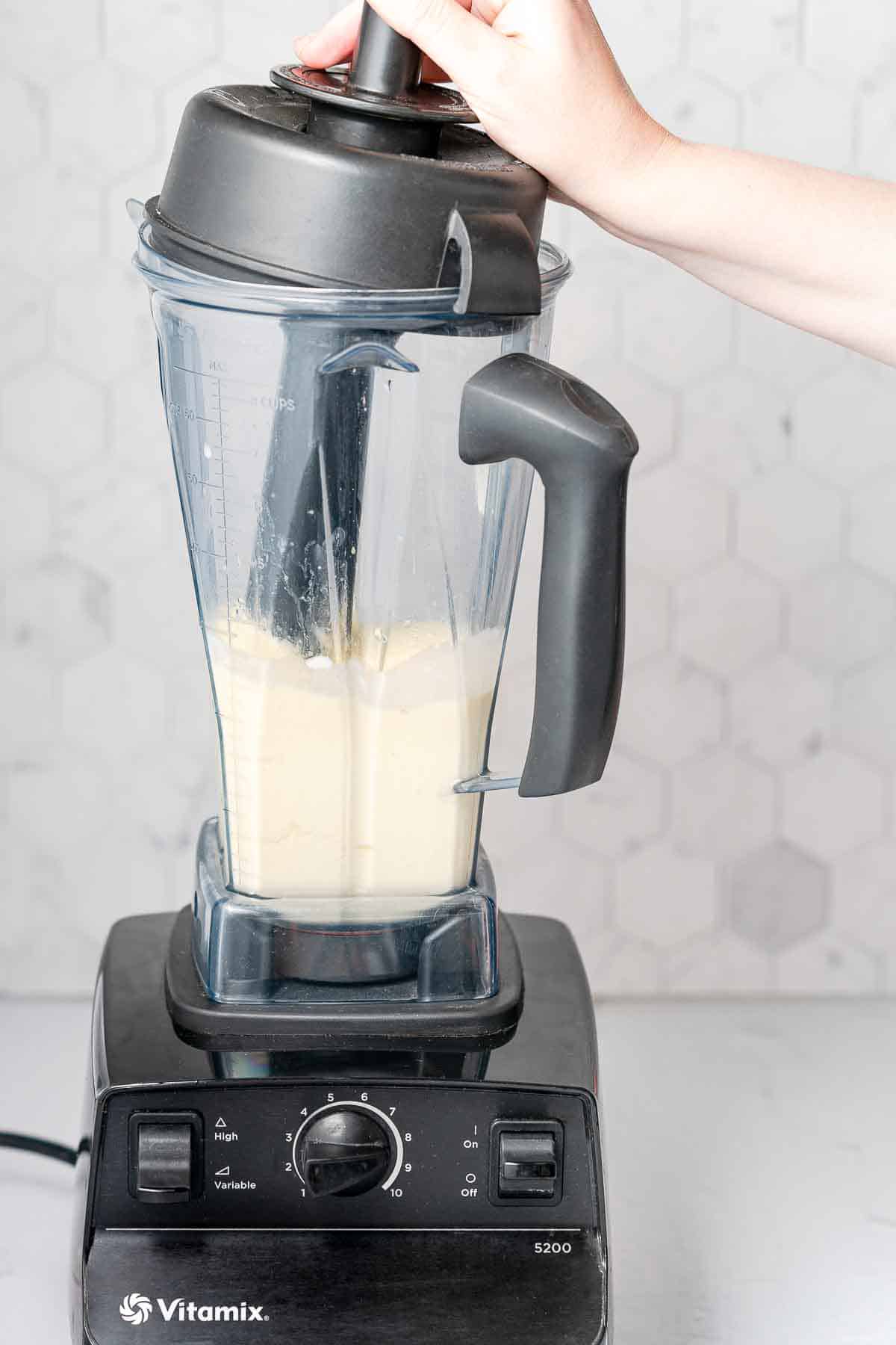 smoothie being blended with tamper