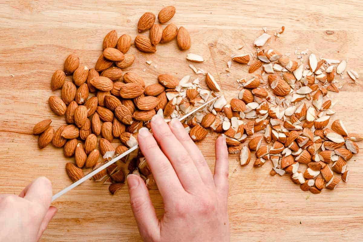 knife chopping almonds into small pieces