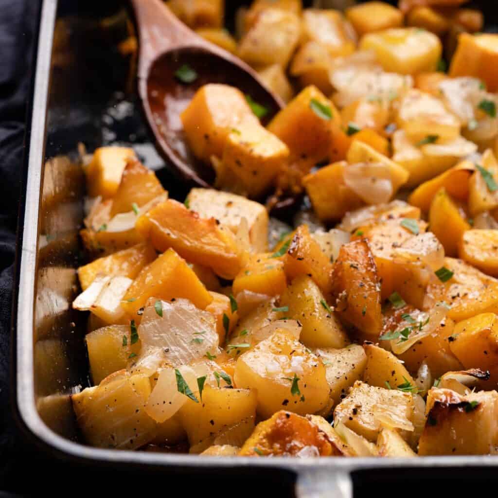 maple glazed squash and apples in pan with spoon
