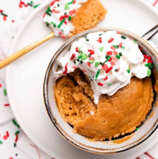 gingerbread mug cake with scoop taken out and spoon sitting on the side
