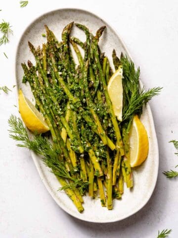 roasted asparagus on platter with lemon garnish