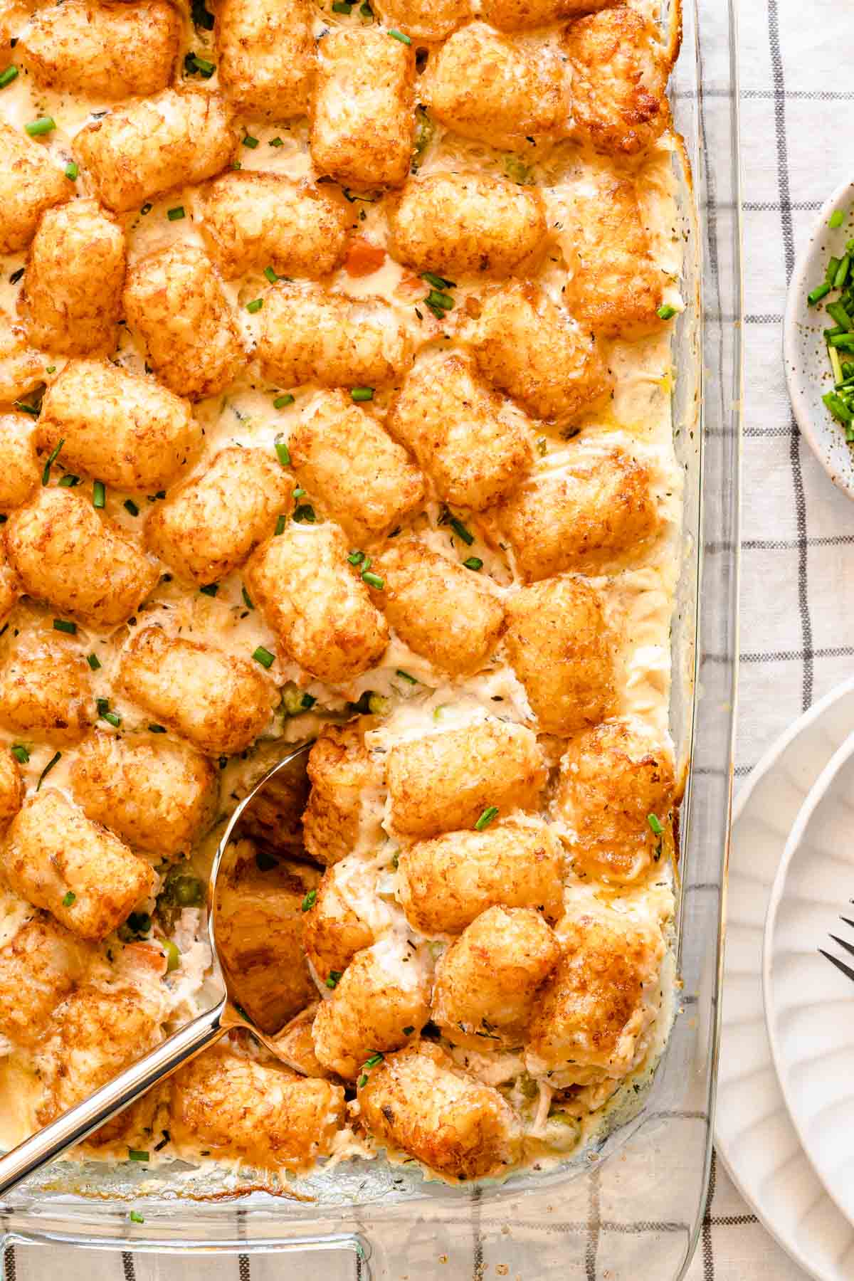 spoon scooping out serving of tater tot casserole