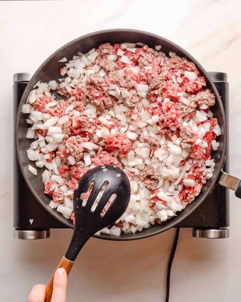 ground beef and onion in pan.