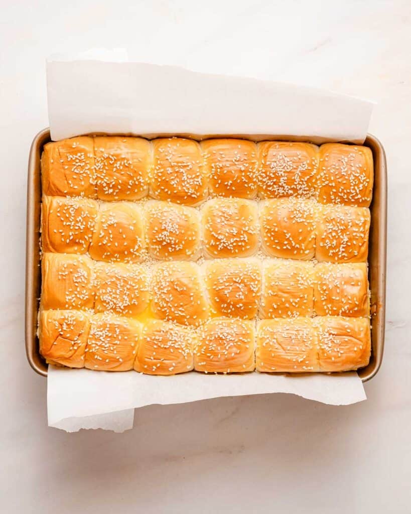 Rolls in pan brushed with butter and sprinkled with sesame seeds.