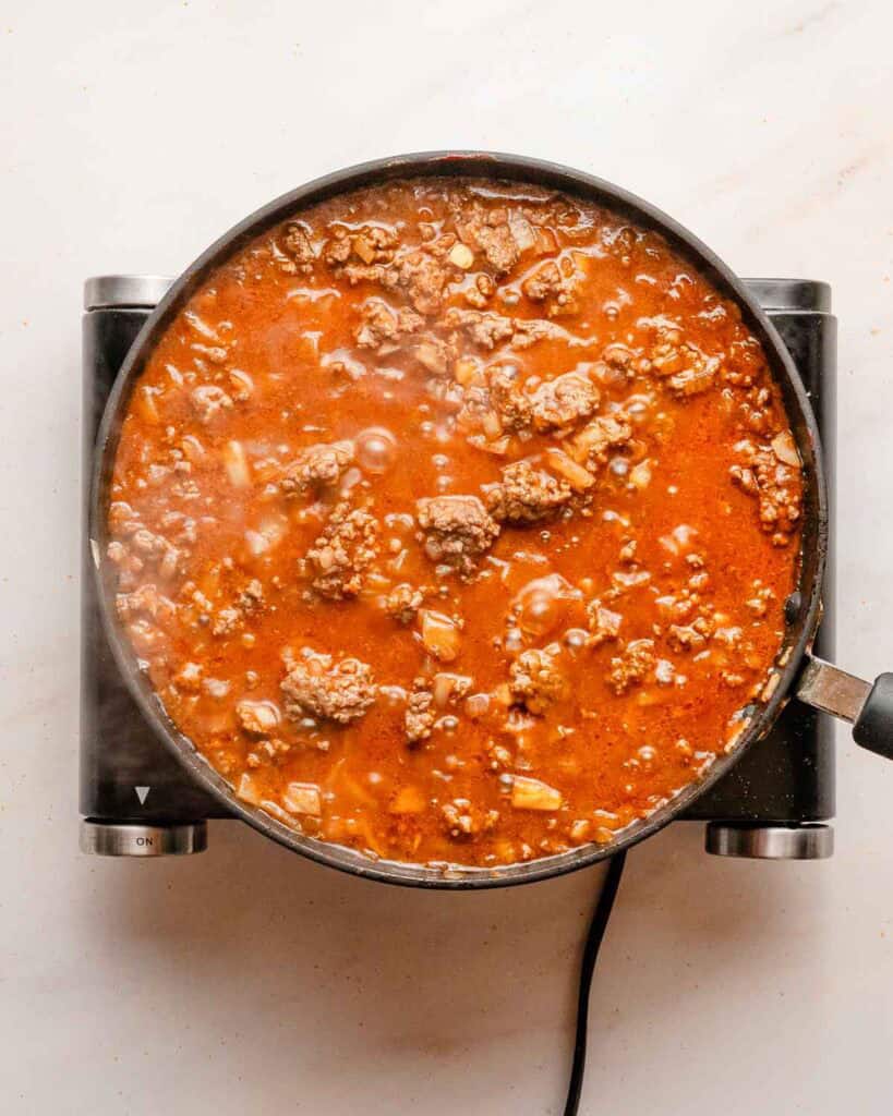 sloppy joe filling simmering in a skillet.
