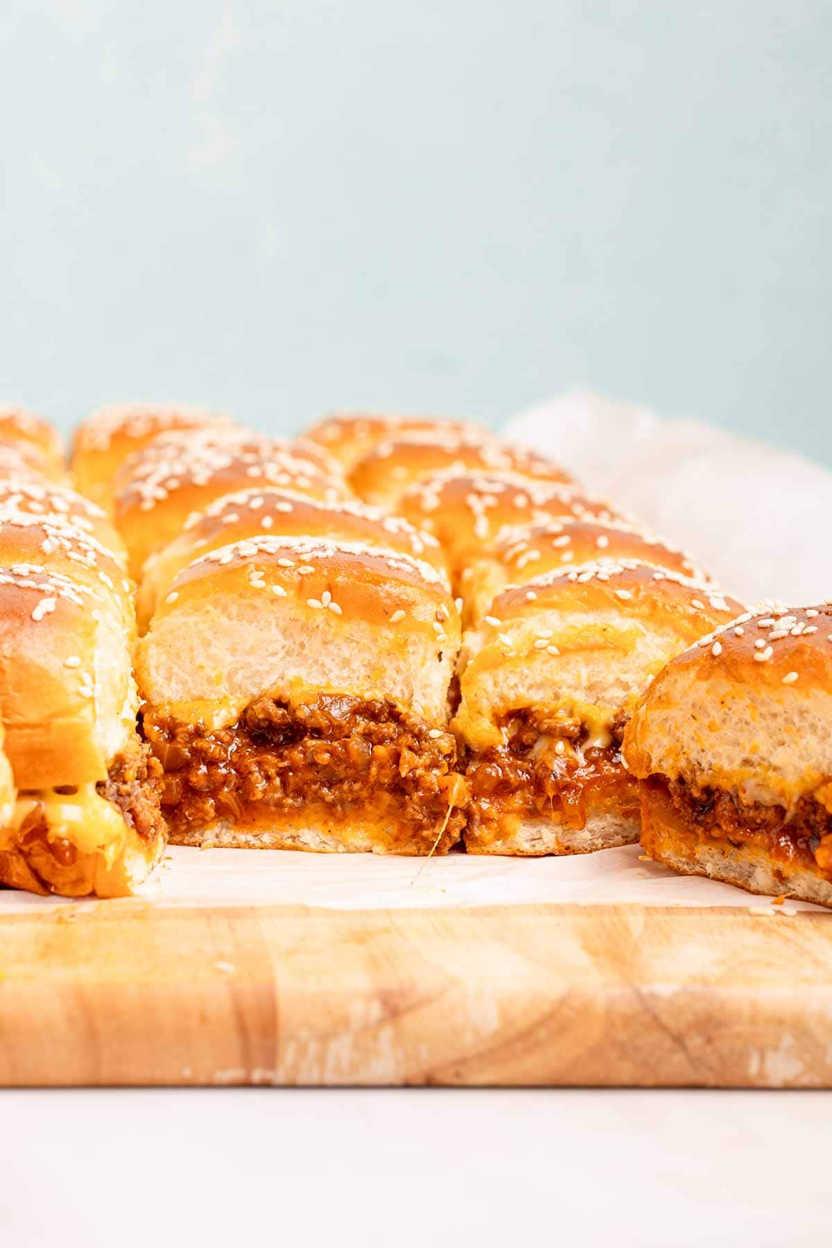 sloppy joe sliders on wooden cutting board.