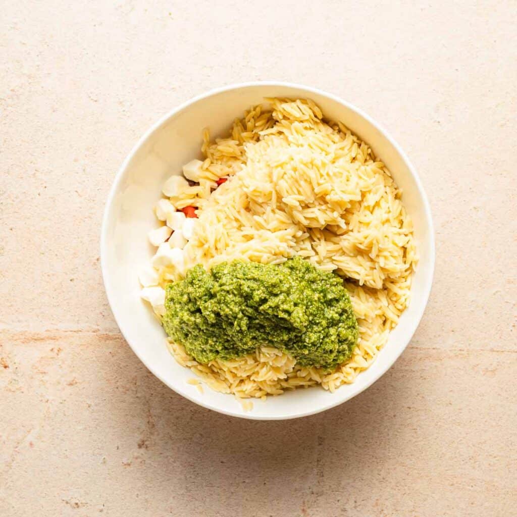 cooked orzo and pesto in a bowl.