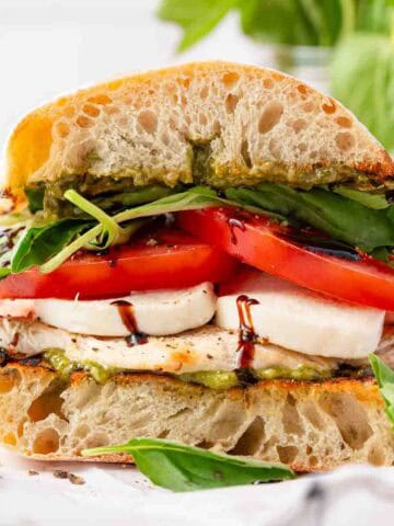 chicken sandwich with basil tomato and mozzarella with balsamic drizzle.