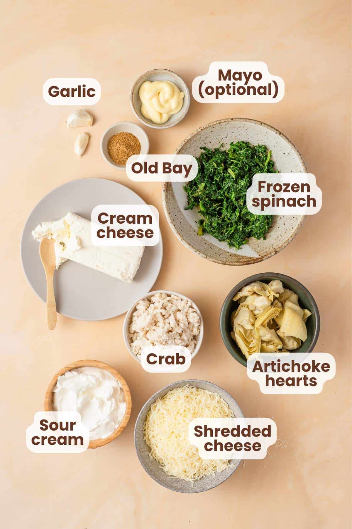 crab spinach artichoke dip ingredients with text labels.