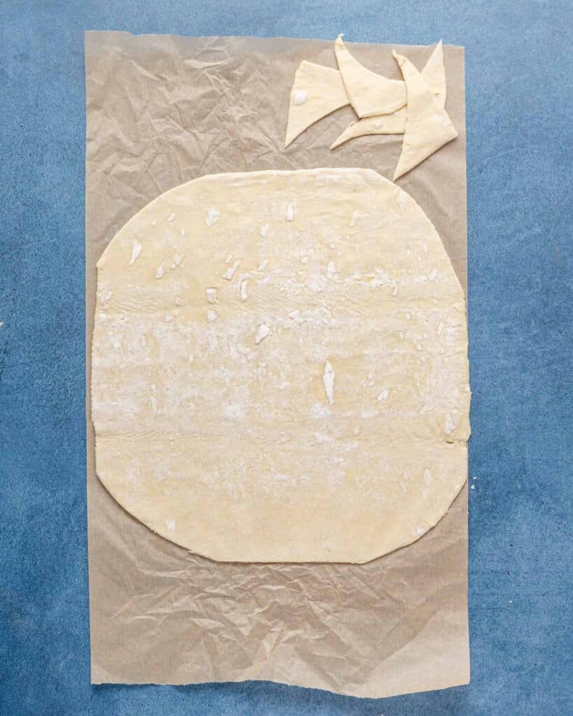 puff pastry in rounded square shape on parchment paper.
