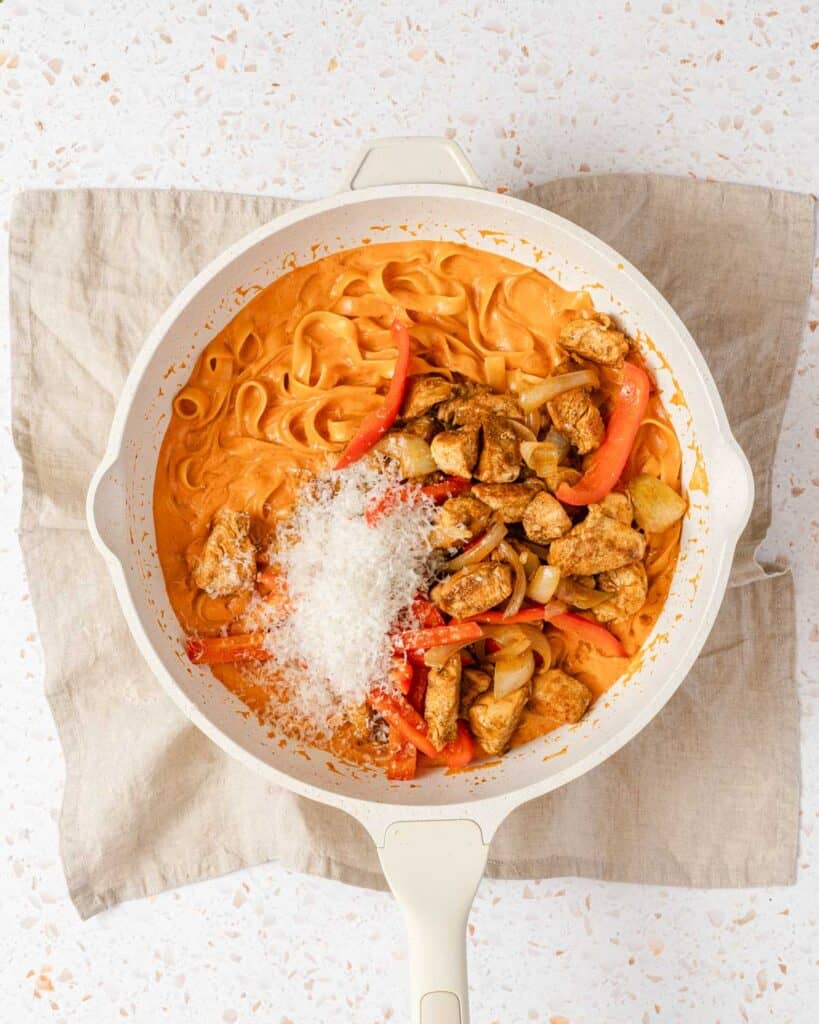 creamy pasta chicken and parmesan in pan.