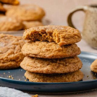 stack of pumpkin cookies on plate.